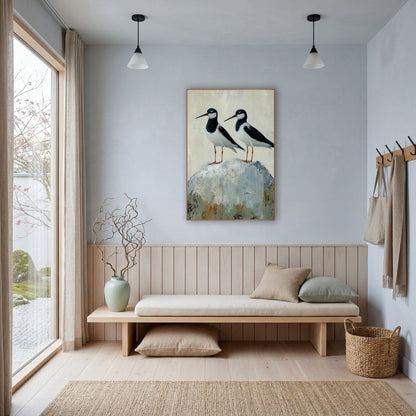 Twin Stilts Gray Boulder Coastal wall art in a bright coastal-style room – two black and white shorebirds with long