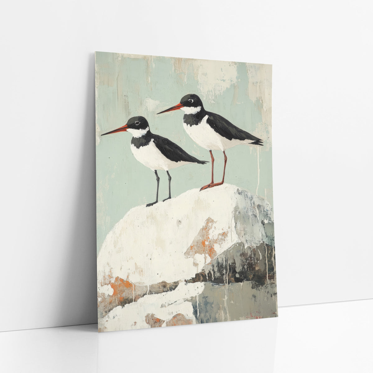 Red Beak Oystercatchers Seafoam Coastal art print leaning against a white wall – two black and white shorebirds