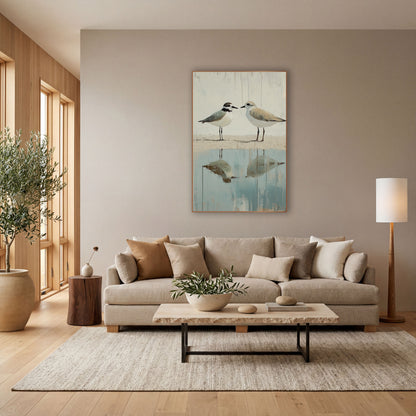 Two Plovers Coastal Shoreline Reflection wall art in a bright coastal-style room – two plovers face each other
