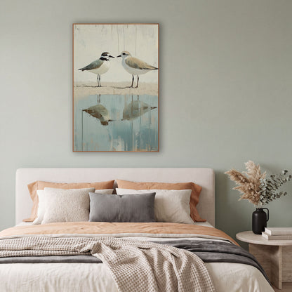 Two Plovers Coastal Shoreline Reflection wall art in a bright coastal-style room – two plovers face each other