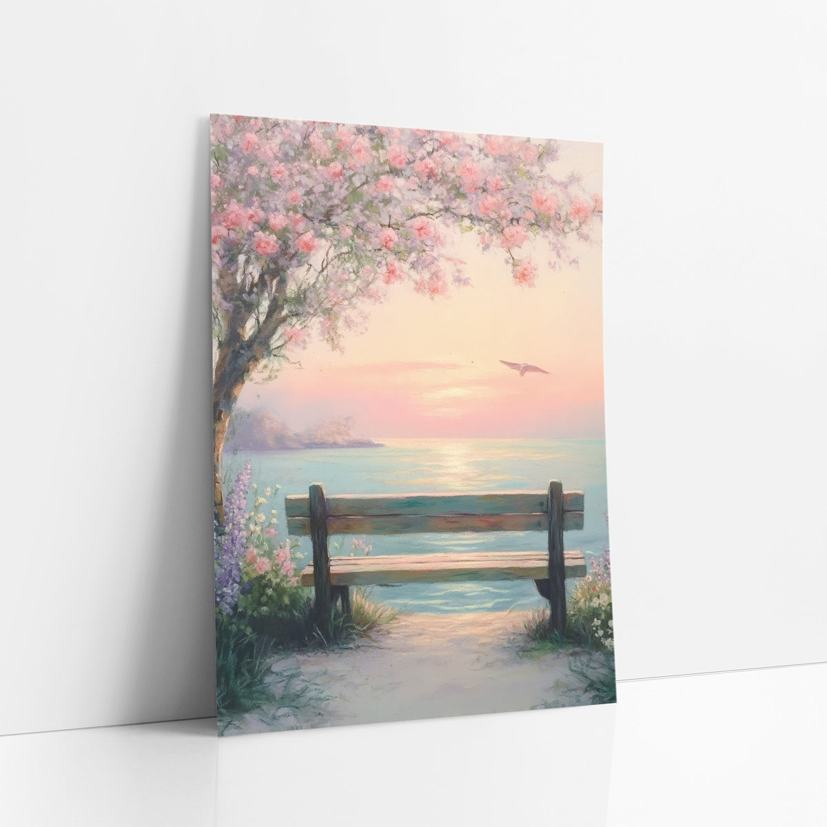 Blossom Bench Seaside Pastel Coastal art print leaning against a white wall – pastel seascape of a wooden bench under pink