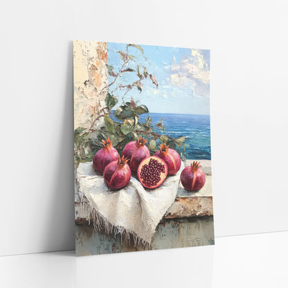 Halved Pomegranate Terrace Coastal art print leaning against a white wall – still life of pomegranates, one cut open