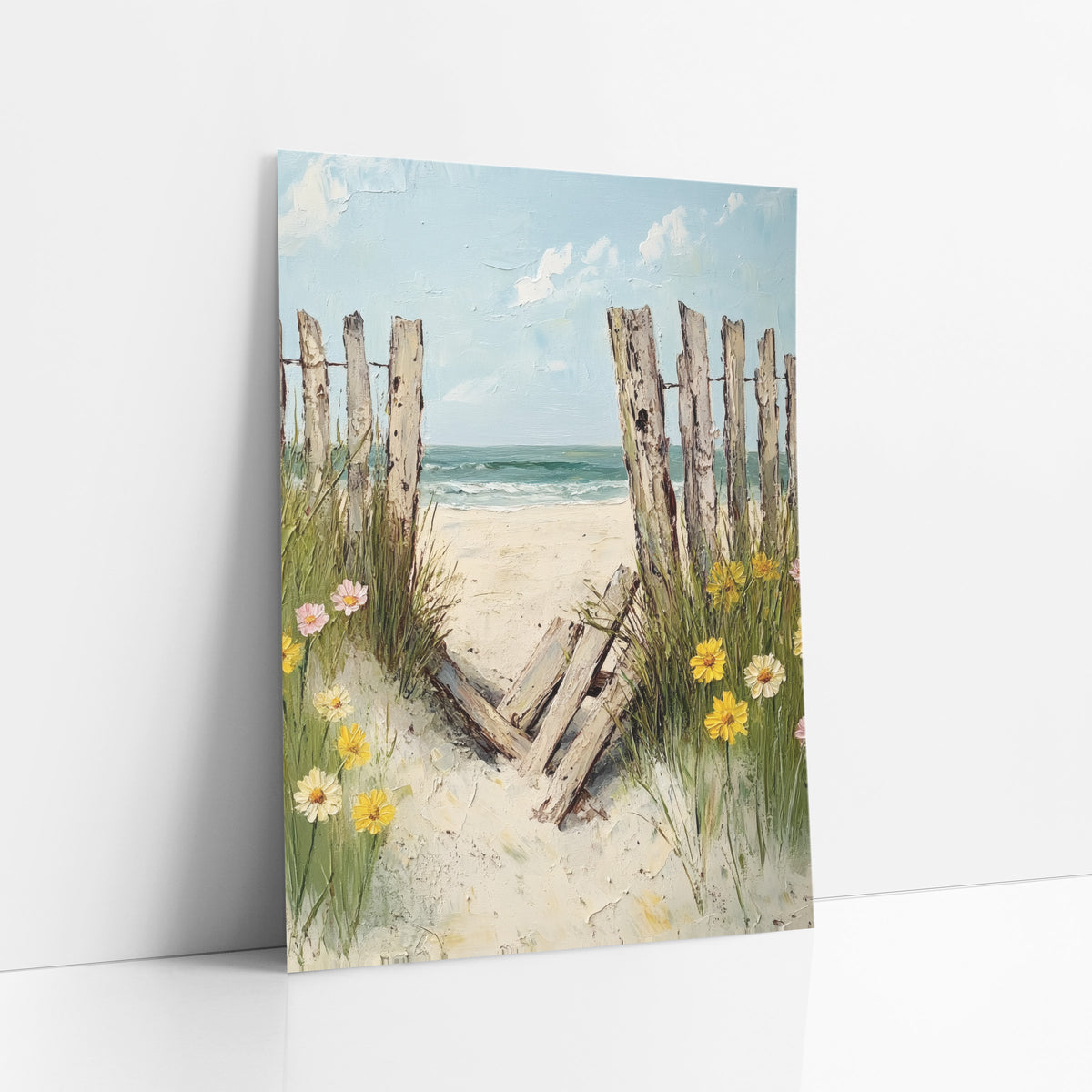 Broken Beach Fence Coastal Daisies art print leaning against a white wall – weathered wooden beach fence with fallen boards