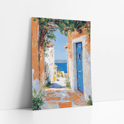 Blue Door Seaside Alley Coastal art print leaning against a white wall – narrow sunlit lane with orange and white walls